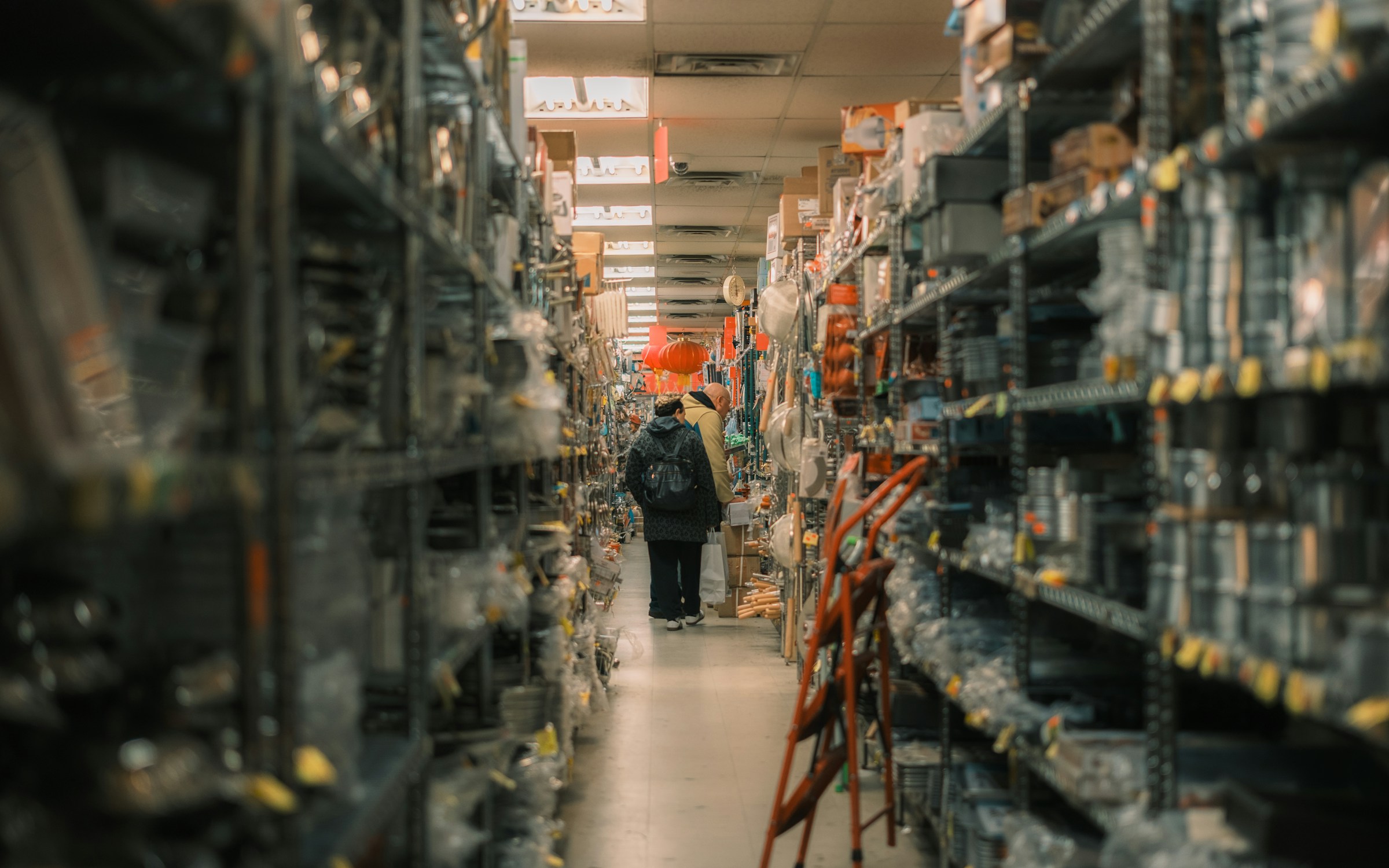 Customer browsing tall warehouse-style retail shelving